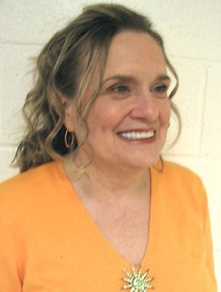 Smiling woman in orange top, side view