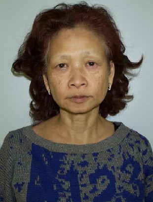 Woman with neutral expression wearing patterned sweater