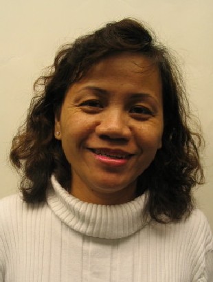 Smiling woman with curly hair wearing white sweater