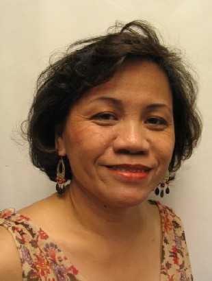 Smiling woman wearing earrings and patterned top